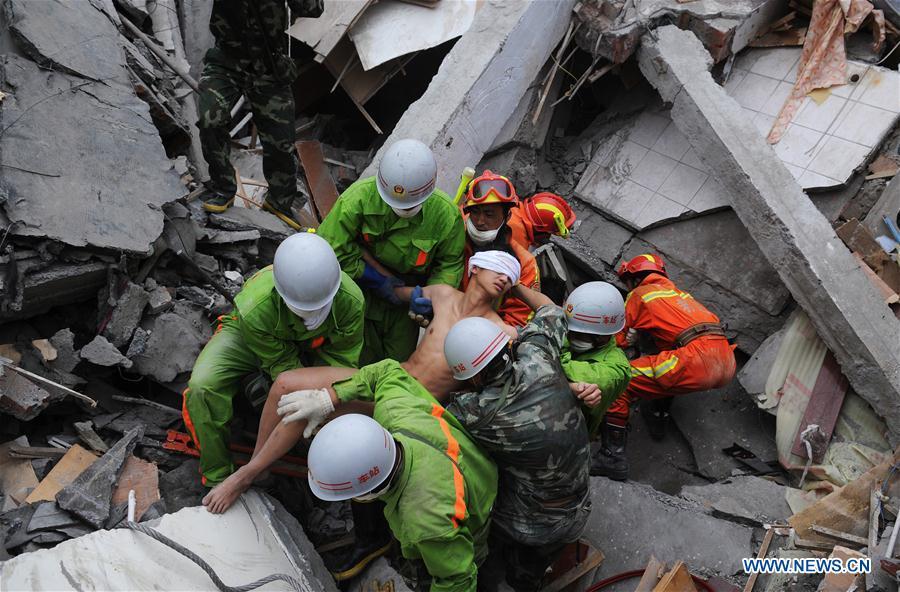 File photo taken on May 17, 2008 shows rescuers carrying Jiang Yuhang, who was trapped for about 123 hours in the rubble, at quake-hit Yingxiu Township of Wenchuan County, southwest China\'s Sichuan Province. The 20-year-old highway administration employee was extricated by firemen from Shanghai, after an 8.0-magnitude earthquake struck Wenchuan on May 12, 2008. Jiang was a survivor of the earthquake which left more than 69,000 dead, 374,000 injured, 18,000 missing and millions homeless. Jiang said it were firefighters who gave him the second life, and he desired to be a soldier like them. At the end of 2008, Jiang realized his dream to join the army and served in the group who once saved him. After training for half a year, he finally became a real fire soldier in Shanghai in 2009. Jiang later got promoted to the position of an officer, and in March this year, he was transferred to the firefighting force in his hometown Kaili City, southwest China\'s Guizhou Province. In the past ten years, the young man, who was saved in that catastrophic earthquake, saved more people\'s lives with his own efforts. (Xinhua/Jiang Hongjing)