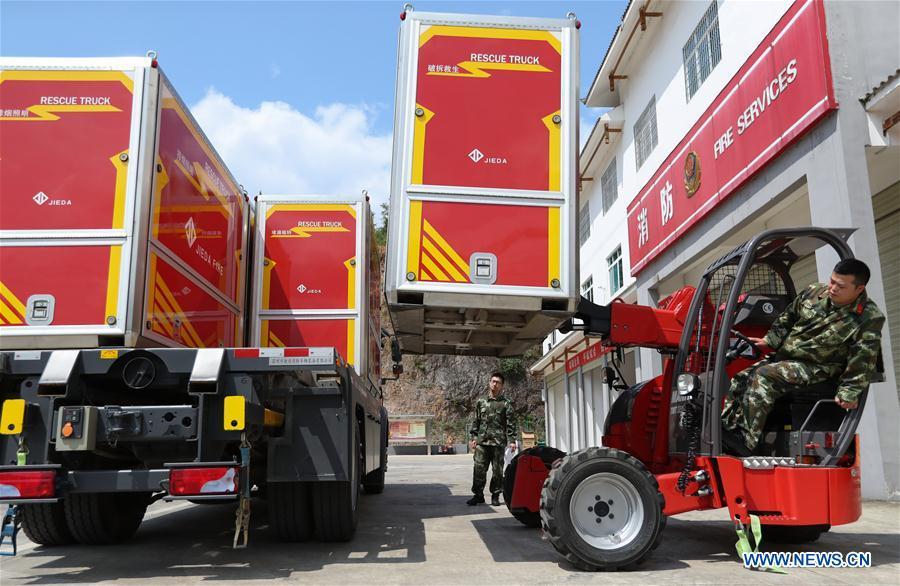 Fire services officer Jiang Yuhang (L) views the operation of a rescue truck in Kaili City, southwest China\'s Guizhou Province, May 8, 2018. On May 17, 2008, Jiang, a 20-year-old highway administration employee, was extricated by firefighters, 123 hours after he was trapped in the rubble at quake-hit Yingxiu Township of Wenchuan County, southwest China\'s Sichuan Province. Jiang was a survivor of the 8.0-magnitude earthquake that struck Sichuan\'s Wenchuan County on May 12, 2008. The quake left more than 69,000 dead, 374,000 injured, 18,000 missing and millions homeless. Jiang said it were firefighters who gave him the second life, and he desired to be a soldier like them. At the end of 2008, Jiang realized his dream to join the army and served in the group who once saved him. After training for half a year, he finally became a real fire soldier in Shanghai in 2009. Jiang later got promoted to the position of an officer, and in March this year, he was transferred to the firefighting force in his hometown Kaili City, southwest China\'s Guizhou Province. In the past ten years, the young man, who was saved in that catastrophic earthquake, saved more people\'s lives with his own efforts. (Xinhua/Jiang Hongjing)