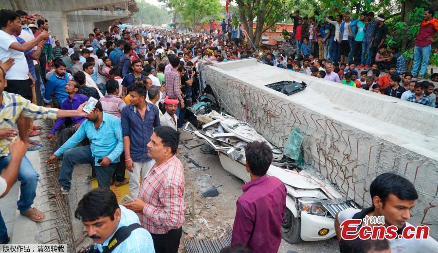 People crowd around the site of an accident where a section of an under construction overpass collapsed in Varanasi, India, May 15, 2018. A highway overpass that was under construction in north India collapsed Tuesday, killing at least 16 people when an immense concrete slab slammed down onto the crowded road below, disaster officials said. (Photo/Agencies)