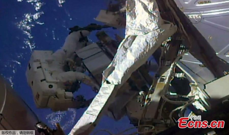 Still image obtained from a video shows a pair of NASA astronauts aboard the International Space Station embarked on a six-and-a-half-hour spacewalk today to upgrade and repair the orbiting outpost. Astronauts Drew Feustel and Ricky Arnold, both veteran spacewalkers, swapped out a leaky cooling component with a replacement on the station’s port-side truss. (Photo/China News Service)