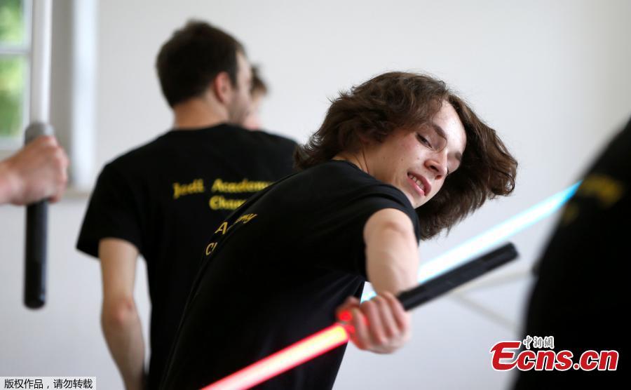 Young people perform during a training session at the \'Jedi Academy Cham\' in Loibling near Cham, Germany, May 19, 2018. The \'Jedi Academy\' is the only registered lightsaber show fight school in Germany. (Photo/Agencies)