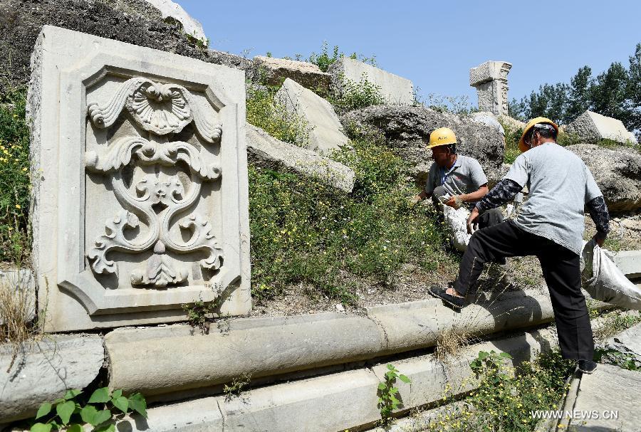 Staff members clean up weeds at ruins of Yuanying Guan (Immense Ocean Observatory) at Yuanmingyuan in Beijing, capital of China, May 23, 2018. The four-month reinforcement project of ruins of Immense Ocean Observatory at the historical site of Yuanmingyuan started lately.(Xinhua/Luo Xiaoguang)