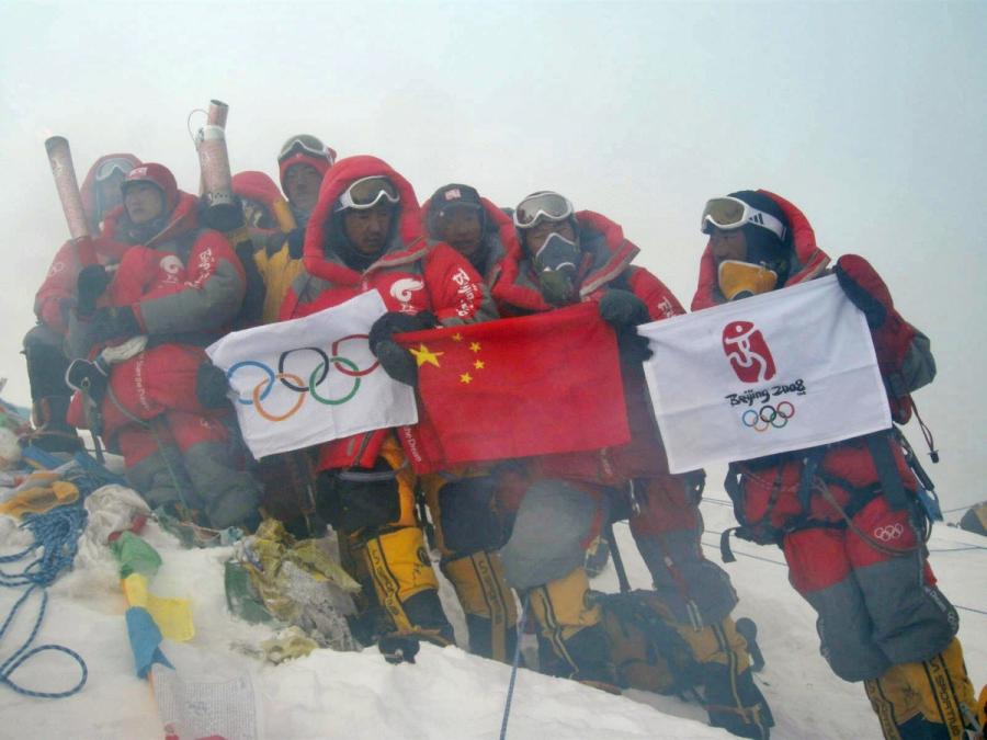 Beijing Olympic Torch is displayed by China Tibet Climbing Team on the summit of Mount Qomolangma on May 8, 2008. The Chinese climbers displayed the Chinese flag, the Olympic Flag and Beijing Olympic Emblem Flag on the summit. (Photo/Xinhua)