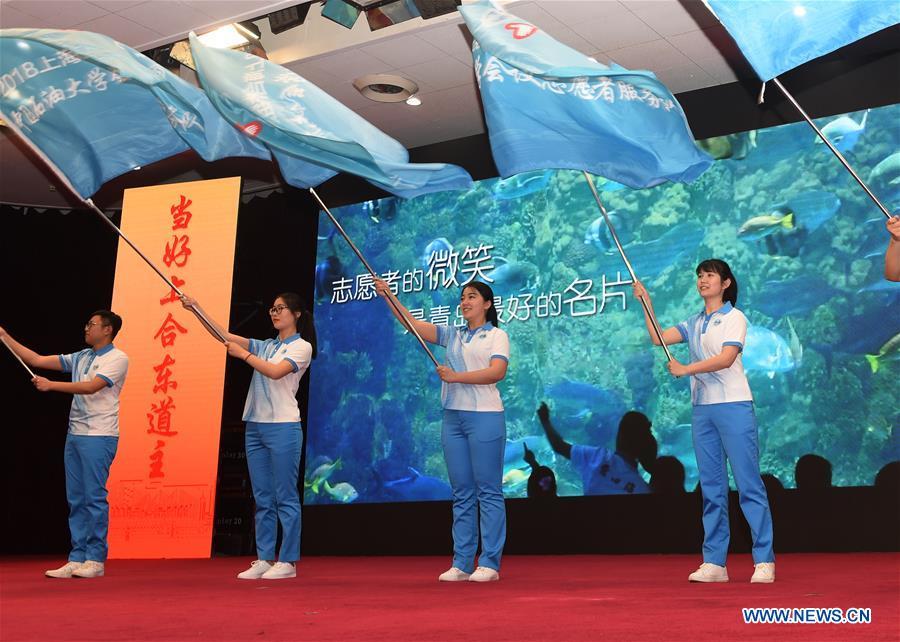Volunteers attend a launch ceremony for the volunteer program for the upcoming Shanghai Cooperation Organization (SCO) summit in Qingdao, east China\'s Shandong Province, May 24, 2018. About 2,000 volunteers will offer services such as assisting with guests\' arrival and departure, translation, and media requests during the 18th summit of the SCO. (Xinhua/Li Ziheng)