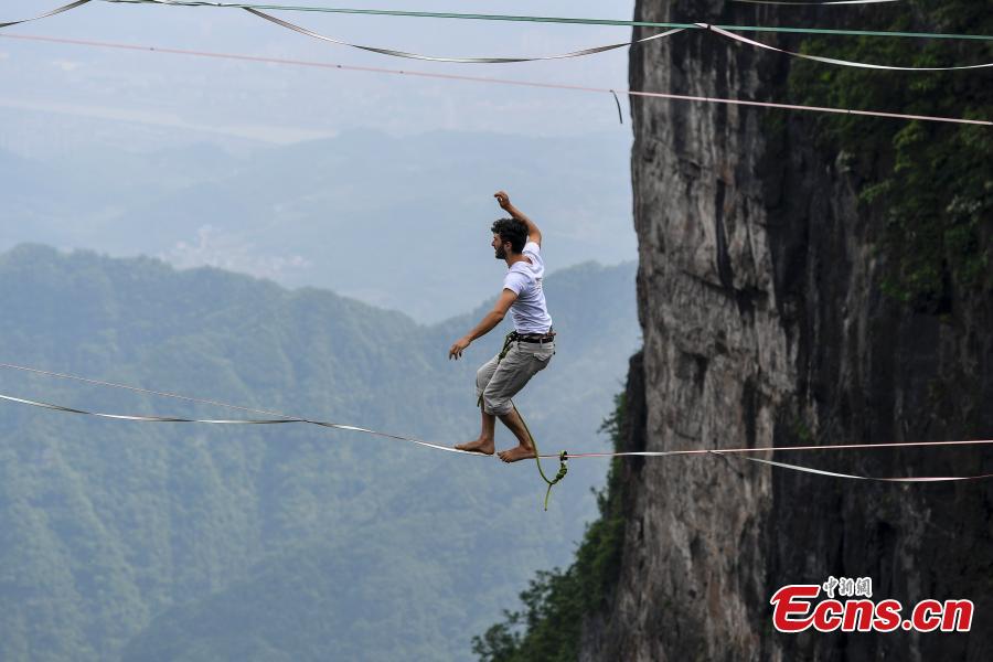 Members of the band HouleDouse perform on slacklines across the 1,400-meter-high cliffs of Tianmen Mountain in Zhangjiajie National Forest Park in central China\'s Hunan province, on Wednesday, May 23, 2018. HouleDouse have made their Asian debut in China, in a show that combines extreme sports with music. (Photo: China News Service/ Yang Huafeng)