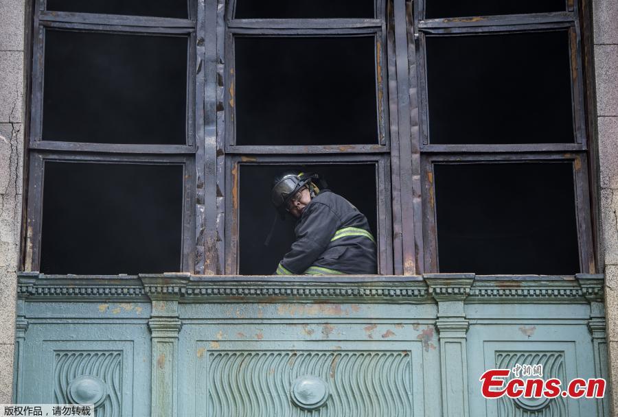 A fireman looks from a window during an operation after a fire engulfed the administrative office of the National Archives of the Philippines in Manila on May 28, 2018. (Photo/Agencies)