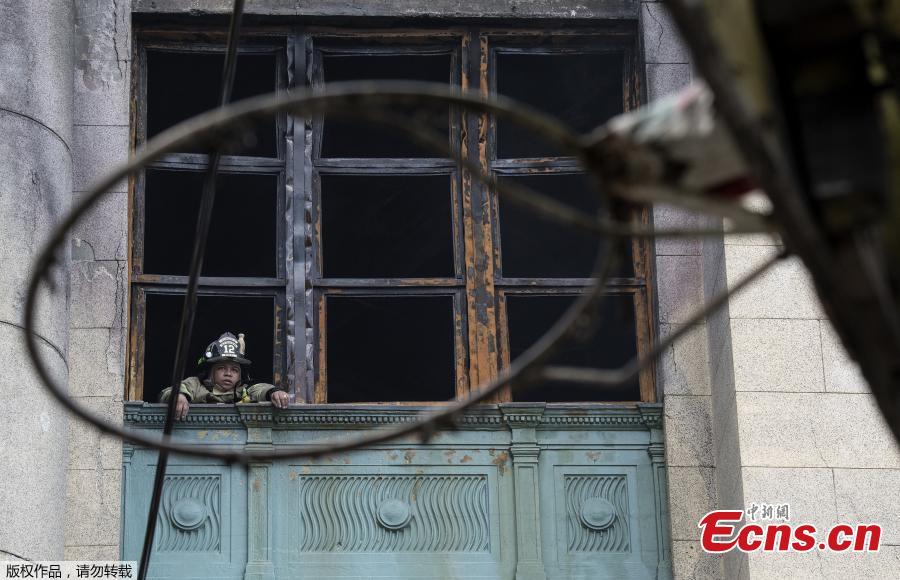 A fireman looks from a window during an operation after a fire engulfed the administrative office of the National Archives of the Philippines in Manila on May 28, 2018. (Photo/Agencies)