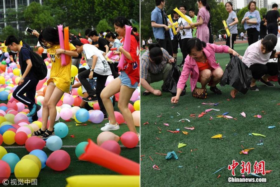 Senior high school pupils trample balloons in an activity to relieve stress ahead of the National College Entrance Exams, or Gaokao, at No.1 High School in Hefei City, East China’s Anhui Province, May 28, 2018. The school prepared 20,000 balloons to allow some 2,000 students a fun break from the test stress. (Photo/VCG)