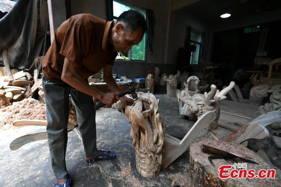 Fang Nengqi, in his 70s, has specialized in making the head piece of a dragon boat for more than 50 years in Fangzhuang Village, Minhou County, East China’s Fujian Province. The village has a 700-year history of dragon-boat making. As fewer young people work to inherit the skills of the traditional craft, the village is now home to just four factories still using ancient simple tools to make the handmade boats. The Dragon Boat Festival is celebrated on the fifth day of the fifth month of the Chinese lunar calendar and falls on June 18 this year. (Photo: China News Service/Wang Dongming)