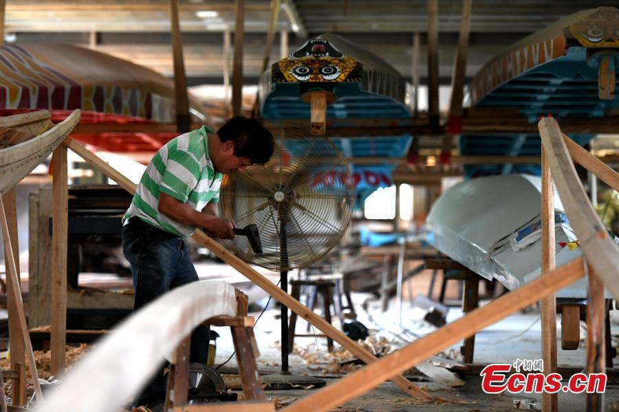 A man works in a dragon boat-making factory in Fangzhuang Village, Minhou County, East China’s Fujian Province, May 30, 2018. The village has a 700-year history of dragon-boat making. As fewer young people work to inherit the skills of the traditional craft, the village is now home to just four factories still using ancient simple tools to make the handmade boats. The Dragon Boat Festival is celebrated on the fifth day of the fifth month of the Chinese lunar calendar and falls on June 18 this year. (Photo: China News Service/Wang Dongming)