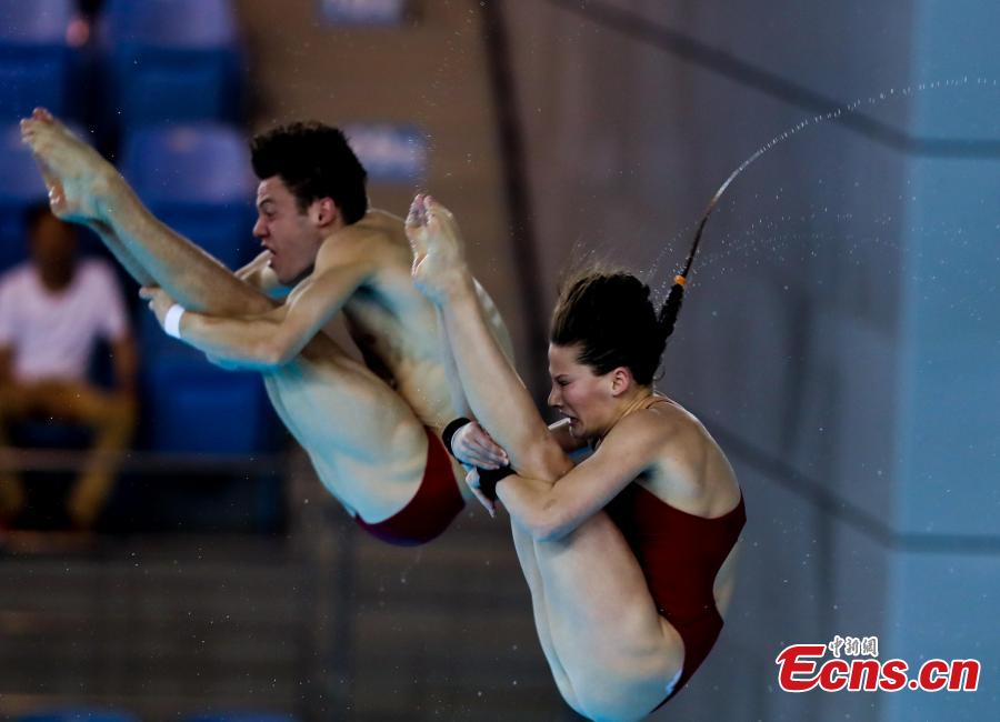 Canadian divers compete in the mixed 10-meter synchronized platform at the FINA Diving World Cup in Wuhan City, Central China’s Hubei Province, June 4, 2018. (Photo: China News Service/Zhang Chang)