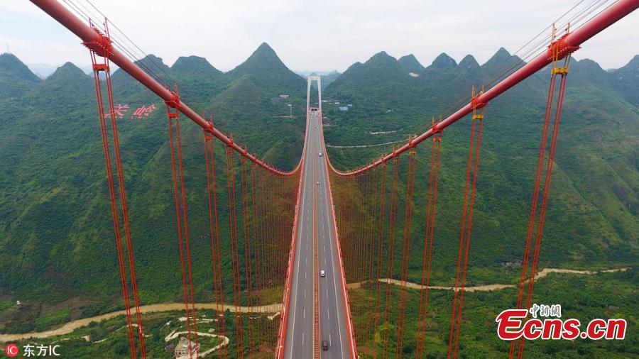 A drone photo shows the Baling River Bridge over a valley in Guanling County, Southwest China’s Guizhou Province, June 5, 2018. At a height of 370 meters above the water, the 1,564-meter-long suspension bridge is the second highest bridge in China and the sixth highest in the world. The bride is unique for having a span of 1,088 meters. (Photo/IC)