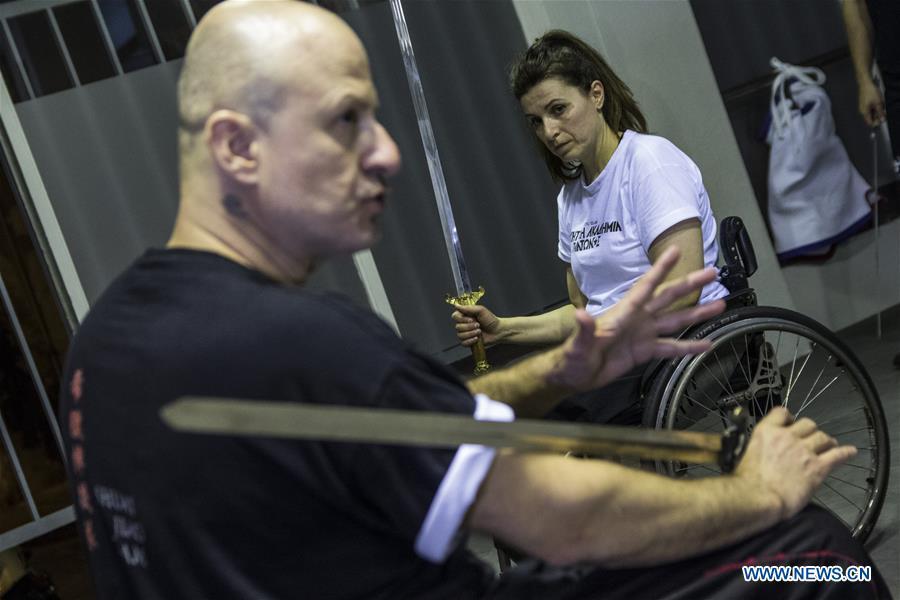 Kostas Moukas (front), a disabled Wushu teacher, teaches in his wheelchair, in Athens, Greece, June 5, 2018. Kostas Moukas started practicing Wushu since 2003 and is the only Wushu teacher in a wheelchair in Greece. He trains mixed classes that include seven disabled athletes who compete officially in the national championships. (Xinhua/Panagiotis Moschandreou)
