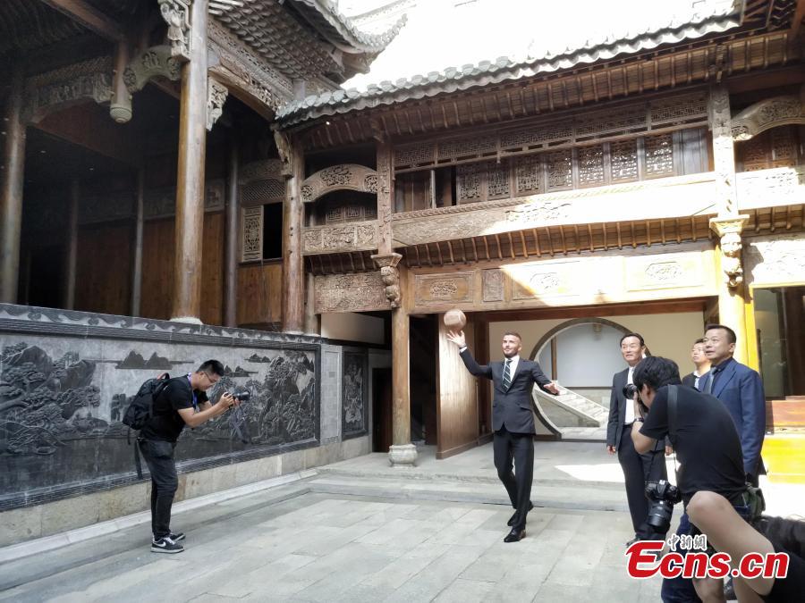 Former professional football star David Beckham plays cuju, known as the origin of modern football, at the Bengbu Ancient Buildings Expo Park ahead of the 2018 G-EXPO Global Top Summit in Bengbu City, East China’s Anhui Province, June 6, 2018. (Photo: China News Service/Zhong Xin)