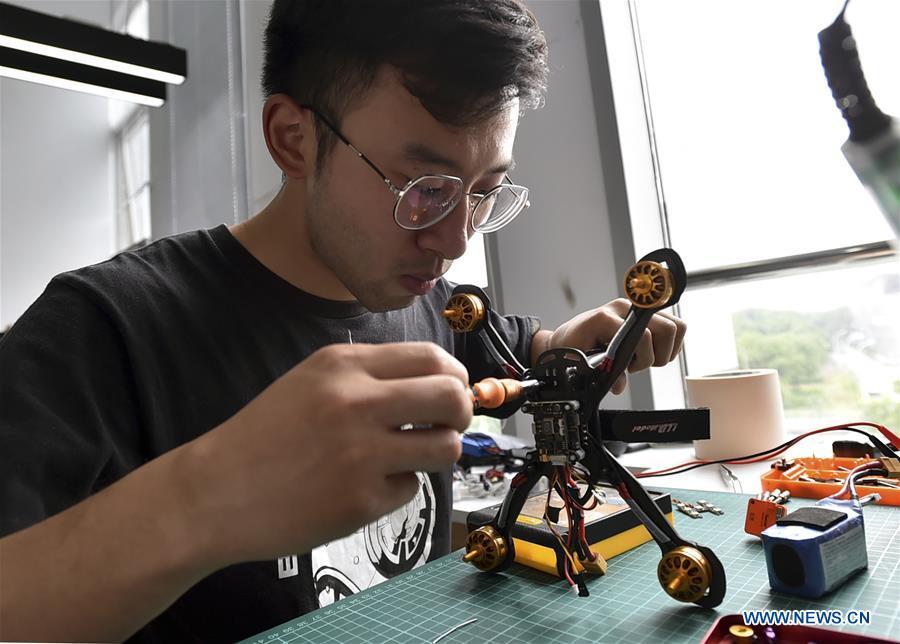 Designer Xu Yiming tests his drone in Yangzhou, east China\'s Jiangsu Province, May 24, 2018. Over the last few years, unmanned aerial vehicles (UAVs) have increasingly embedded in everyday life all around China. The duties of these civil drones range from agriculture, transportation to entertainment. The commercial sector relies on unmanned platforms for a variety of services, including aerial photography, crop monitoring, rescuing, delivering and performances. The wide use of drones not only makes life more convenient, but also broadens the imagination of Chinese people towards the coming future. (Xinhua/Zhuang Wenbin)