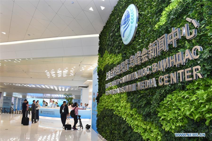 Journalists do preparation work at the Media Center of the Shanghai Cooperation Organization (SCO) Qingdao Summit in Qingdao, east China\'s Shandong Province, June 6, 2018. The media center of the summit will open to journalists from home and abroad from June 6 to 11. (Xinhua/Li Ziheng)