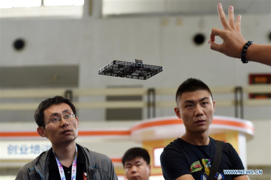 Visitors watch a demonstration of a drone taking pictures during the 20th China Beijing International High-tech Expo, in Beijing, capital of China, June 8, 2017. Over the last few years, unmanned aerial vehicles (UAVs) have increasingly embedded in everyday life all around China. The duties of these civil drones range from agriculture, transportation to entertainment. The commercial sector relies on unmanned platforms for a variety of services, including aerial photography, crop monitoring, rescuing, delivering and performances. The wide use of drones not only makes life more convenient, but also broadens the imagination of Chinese people towards the coming future. (Xinhua/Ju Huanzong)