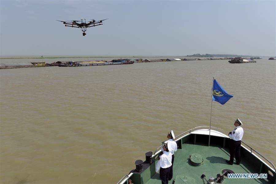 Maritime personnel use a drone to patrol on the Hongze Lake in Huai\'an of east China\'s Jiangsu Province, May 15, 2018. Over the last few years, unmanned aerial vehicles (UAVs) have increasingly embedded in everyday life all around China. The duties of these civil drones range from agriculture, transportation to entertainment. The commercial sector relies on unmanned platforms for a variety of services, including aerial photography, crop monitoring, rescuing, delivering and performances. The wide use of drones not only makes life more convenient, but also broadens the imagination of Chinese people towards the coming future. (Xinhua/Chen Liang)