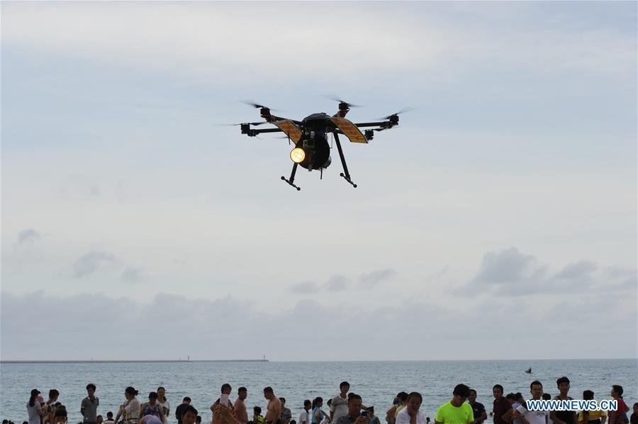 A rescue drone capable of broadcasting and issuing warnings, patrols above a beach area in Sanya of south China\'s Hainan Province, May 30, 2017. Over the last few years, unmanned aerial vehicles (UAVs) have increasingly embedded in everyday life all around China. The duties of these civil drones range from agriculture, transportation to entertainment. The commercial sector relies on unmanned platforms for a variety of services, including aerial photography, crop monitoring, rescuing, delivering and performances. The wide use of drones not only makes life more convenient, but also broadens the imagination of Chinese people towards the coming future. (Xinhua/Sha Xiaofeng)