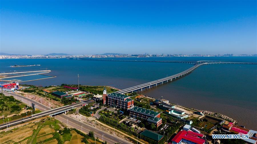 Aerial photo taken on June 1, 2018 shows the Qingdao Jiaozhou Bay Bridge in Qingdao, east China\'s Shandong Province. The 36.48-km cross-sea bridge connects the urban district of Qingdao City to its Huangdao district. (Xinhua/Guo Xulei)