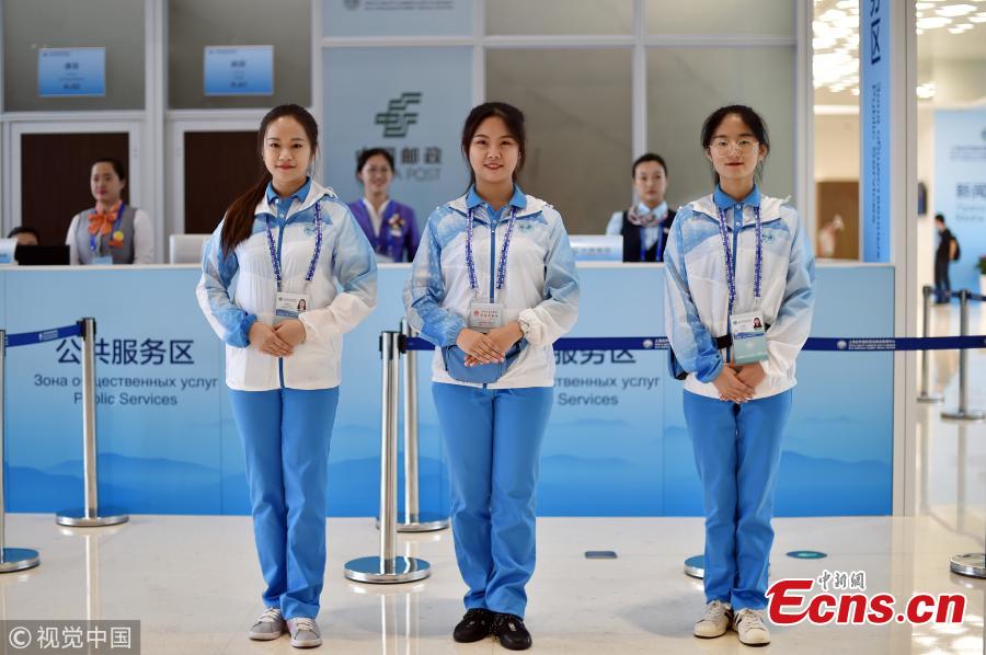 Volunteers work at the press center of the Shanghai Cooperation Organization Qingdao Summit in Qingdao City, East China’s Shandong Province, June 7, 2018. Some 370 volunteers from four universities in Qingdao are assisting journalists from home and abroad at the press center. (Photo/VCG)