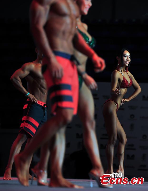 Contestants perform in the China Bodybuilding Championships in Tianjin, June 7, 2018. Organized by the Chinese Bodybuilding Association, the championships included seven events and attracted 698 participants from 165 cities. The event also selected Mr. Physique and Miss Bikini. (Photo: China News Service/Tong Yu)