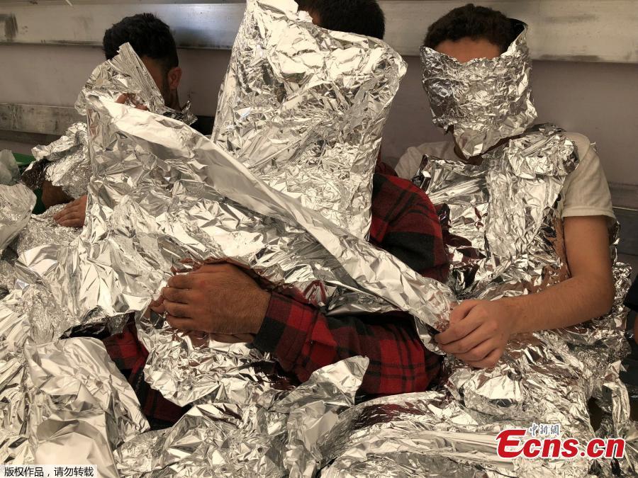 Photo taken on June 6, 2018 shows customs enforcement officers in Istanbul’s Pendik port have caught undocumented migrants, wrapped in aluminum foil to hide from x-ray detectors, on an 18-wheel truck en route to Italy. (Photo/Agencies)