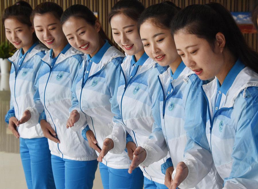 Volunteers are being trained for the 18th Shanghai Cooperation Organization Summit in Qingdao, Shandong province, on Friday. [Photo by Feng Yongbin/China Daily]

\