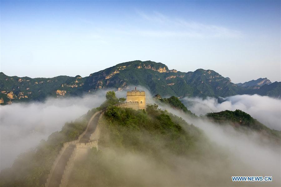 Photo taken on May 13, 2018 shows sea of clouds after rainfall at Huangyaguan section of the Great Wall in Tianjin, north China.(Xinhua/Yang Yushan)
4. The Great Wall

Just like a gigantic dragon, the Great Wall winds up and down across deserts, grasslands, mountains and plateaus, stretching from east to west of China. 

It begins in the east at Shanhaiguan in Hebei province and ends at Jiayuguan in Gansu province to the west. Its main body consists of walls, horse tracks, watch towers, and shelters on the wall, and includes fortresses and passes along the Wall.

With a history of more than 2,000 years, some of the sections are now in ruins or have disappeared. However, it is still one of the most appealing attractions all around the world owing to its architectural grandeur and historical significance.

The Great Wall, one of the greatest wonders of the world, was listed as a World Heritage by UNESCO in 1987.