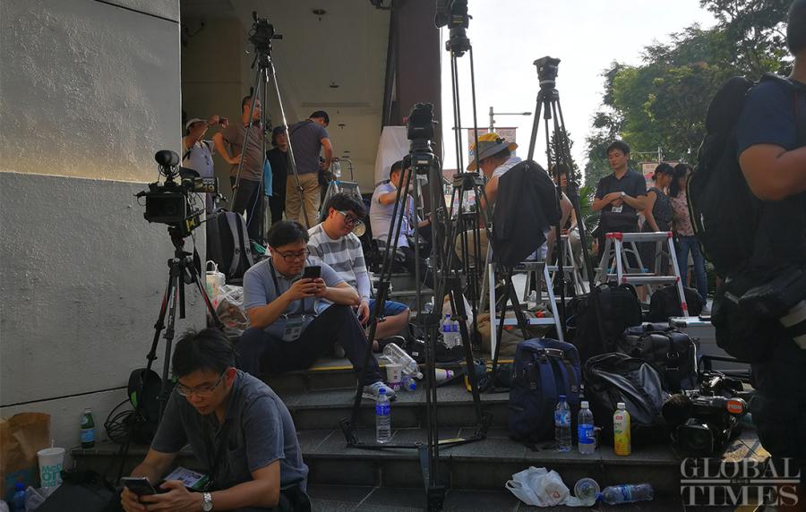Journalists prepare outside the St. Regis hotel where DPRK leader Kim Jong-un has stayed in Singapore on Sunday. (Photo: Yang Sheng/GT)