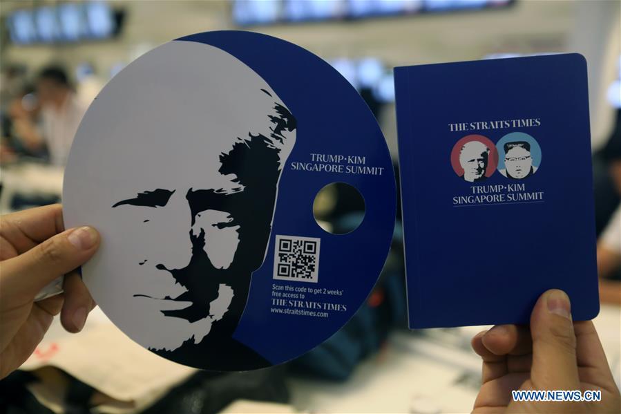 Themed fan and notebook are seen at the international media center in Singapore, June 10, 2018. The much-anticipated meeting between U.S. President Donald Trump and Kim Jong Un, top leader of the Democratic People\'s Republic of Korea (DPRK) is to start here on Tuesday. (Xinhua/Li Peng)