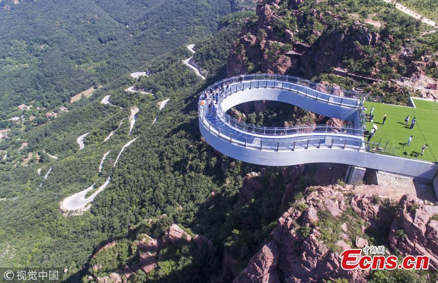 A skywalk is ready to open to the public in Fuxi Mountain scenic area in Xinmi City, Central China’s Henan Province, June 12, 2018. Built with 3,000 tons of steel, the U-shaped cantilevered glass walkway is 360 meters above the canyon floor and extends 30 meters past the cliff edge. (Photo/VCG)