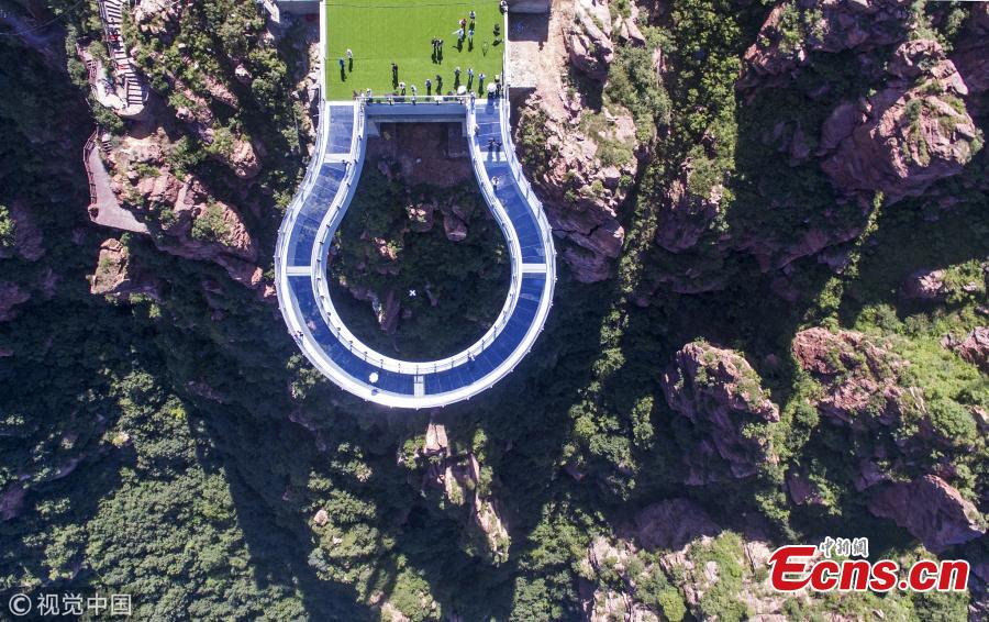 A skywalk is ready to open to the public in Fuxi Mountain scenic area in Xinmi City, Central China’s Henan Province, June 12, 2018. Built with 3,000 tons of steel, the U-shaped cantilevered glass walkway is 360 meters above the canyon floor and extends 30 meters past the cliff edge. (Photo/VCG)