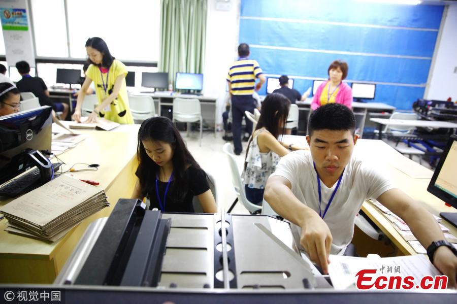Teachers grade test papers of the national college entrance exam, known as gaokao, at Hainan Normal University in Haikou City, South China’s Hainan Province, June 12, 2018. The province’s 699 teachers will be responsible for grading gaokao test papers from June 14 to 20 at well-guarded sites. (Photo/VCG)