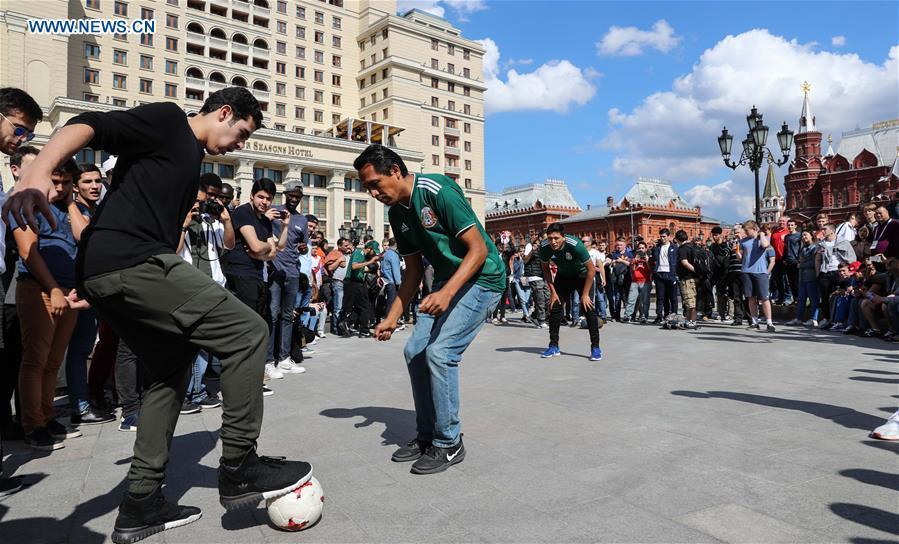 Fans play soccer near the Red Square in Moscow, Russia, on June 13, 2018. The 2018 Russia World Cup will kick off on June 14. (Xinhua/Yang Lei)