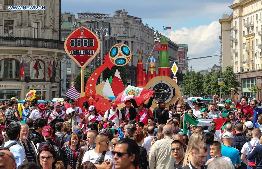 Fans cheer in front of a countdown clock near the Red Square in Moscow, Russia, on June 13, 2018. The 2018 Russia World Cup will kick off on June 14. (Xinhua/Yang Lei)