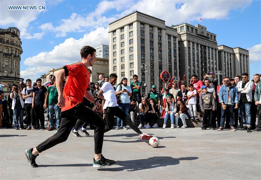 Fans play soccer near the Red Square in Moscow, Russia, on June 13, 2018. The 2018 Russia World Cup will kick off on June 14. (Xinhua/Yang Lei)