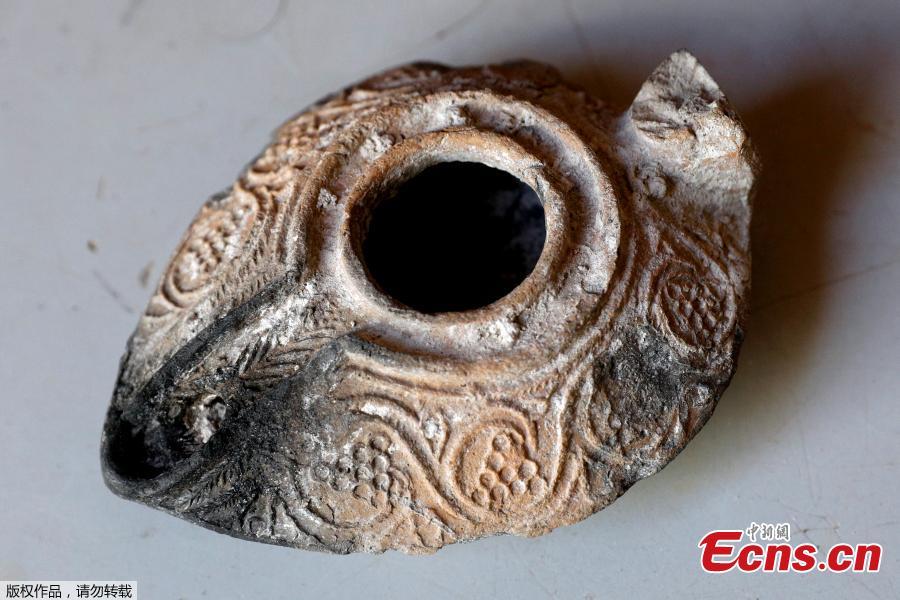 <?php echo strip_tags(addslashes(Israeli archaeologists have unearthed a rare 1,000-year-old clay amulet bearing an inscription in Arabic at a parking lot in the East Jerusalem, Israel's antiquities authority said Thursday, June 14, 2018. The tiny object, which has a diameter of less than 1 centimeter, was dug up at the Givati Parking Lot just outside Jerusalem's Old City, and is inscribed with the following two-line personal prayer: 