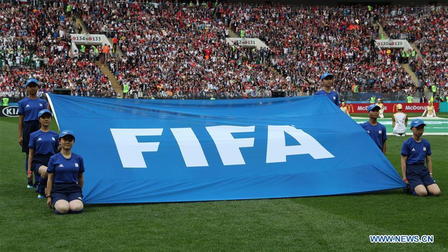 Chinese caddies hold a FIFA flag before the opening match of the 2018 FIFA World Cup in Moscow, Russia, on June 14, 2018. (Xinhua/Yang Lei)