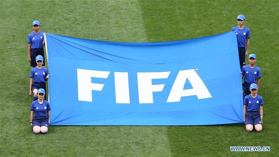 <?php echo strip_tags(addslashes(Chinese caddies hold a FIFA flag before the opening match of the 2018 FIFA World Cup in Moscow, Russia, on June 14, 2018. (Xinhua/Cao Can))) ?>