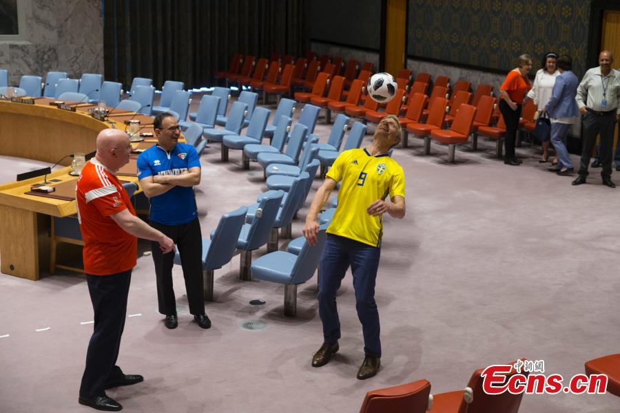 Members of the United Nations Security Council pose for a picture while wearing soccer jerseys to commemorate the inauguration of the World Cup, at the United Nations headquarters in New York City, New York, U.S, June 14, 2018. (Photo: China News Service/Liao Pan)
