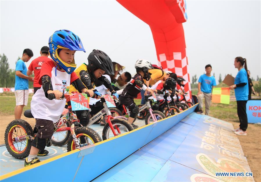 <?php echo strip_tags(addslashes(Children take part in a balance bike contest at a park in Gu'an County, north China's Hebei Province, June 16, 2018. More than 300 children from Beijing, Tianjin and Hebei participated in the activity on Saturday. (Xinhua/Men Congshuo))) ?>