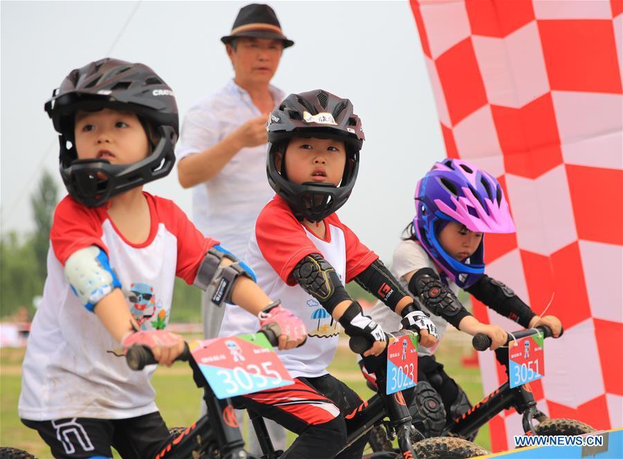 <?php echo strip_tags(addslashes(Children take part in a balance bike contest at a park in Gu'an County, north China's Hebei Province, June 16, 2018. More than 300 children from Beijing, Tianjin and Hebei participated in the activity on Saturday. (Xinhua/Men Congshuo))) ?>