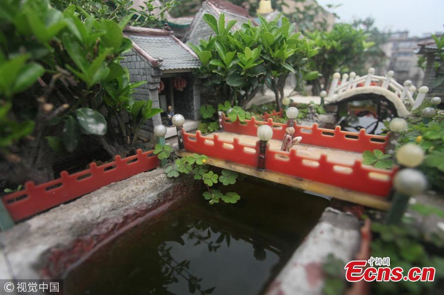 Yu Zuofu, an enthusiast of miniature buildings and landscapes, shows his creation in Anshan City, Liaoning Province. Yu, 79, developed the interest in making very small buildings with waste chopsticks or ice lolly sticks after his retirement. Among the more than 200 miniature creations, his first work was a replica of Daguanyuan, or Grand View Garden, depicted in the classical novel Dream of the Red Chamber. (Photo/VCG)