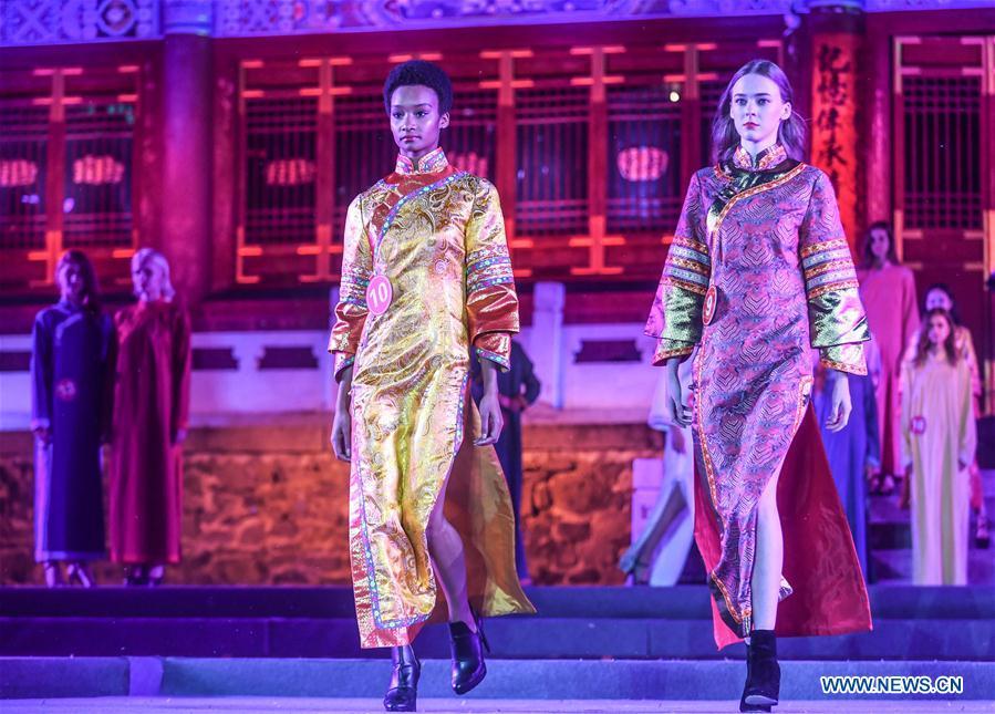 Models show cheongsam, traditional Chinese women\'s dress also known as Qipao, during the 1st international qipao model competition in Xinbin Manchu Autonomous County in Fushun City, northeast China\'s Liaoning Province, June 23, 2018. (Xinhua/Pan Yulong)