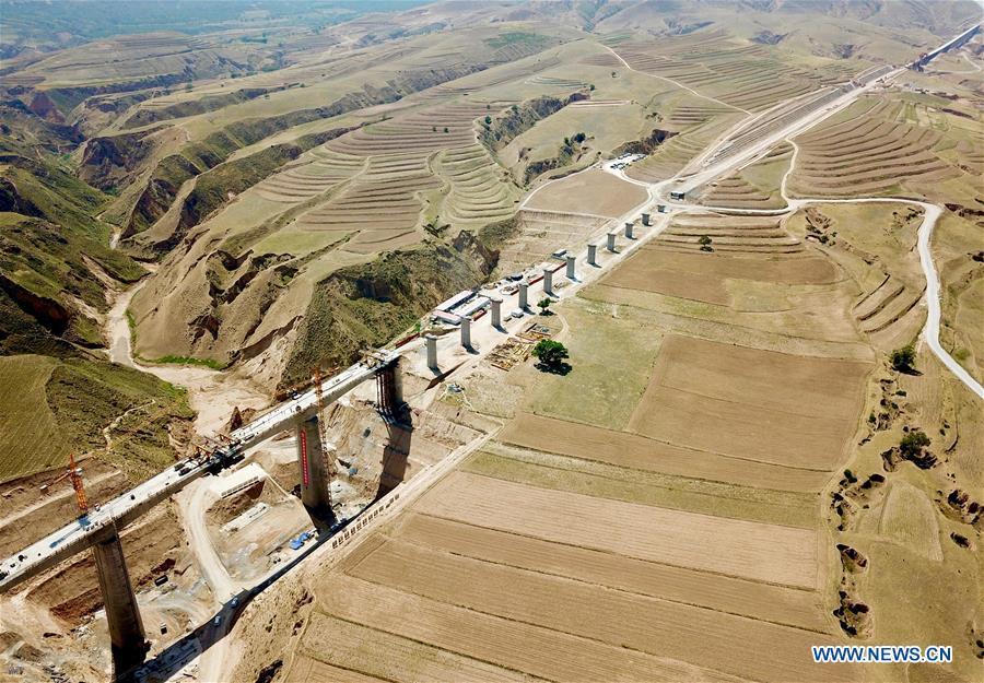 In this aerial photo taken on June 23, 2018, workers construct a bridge in the Gansu-Ningxia section of the Yinchuan-Xi\'an high-speed railway in northwest China\'s Ningxia Hui Autonomous Region. The 617-kilometer high-speed railway is scheduled to start operation by the end of 2020 with a design speed of 250 kilometers per hour. (Xinhua/Hou Dongtao)