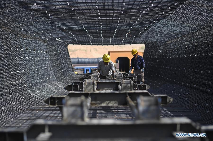 Workers make prefabricated building parts for the Gansu-Ningxia section of the Yinchuan-Xi\'an high-speed railway in northwest China\'s Ningxia Hui Autonomous Region, June 23, 2018. The 617-kilometer high-speed railway is scheduled to start operation by the end of 2020 with a design speed of 250 kilometers per hour. (Xinhua/Wang Peng)