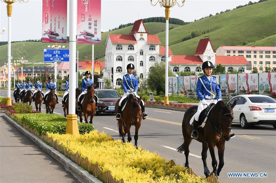 <?php echo strip_tags(addslashes(Members of a female mounted patrol unit are seen on duty in Arxan, north China's Inner Mongolia Autonomous Region, June 24, 2018. Every year, the female mounted patrol unit of Arxan will patrol the city between June and October, the high season for tourism. Apart from regular patrols, the members are also expected to perform ceremonial tasks on formal occasions. (Xinhua/Liu Lei))) ?>