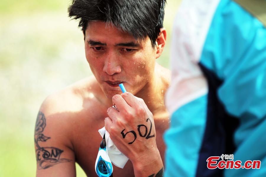 An exhausted participant breathes oxygen after finishing a swimming race across the Yellow River in Xunhua Salar Autonomous County, Northwest China’s Qinghai Province, June 24, 2018. The race on China’s second longest river was 500 meters long. (Photo: China News Service/Zhang Tianfu)