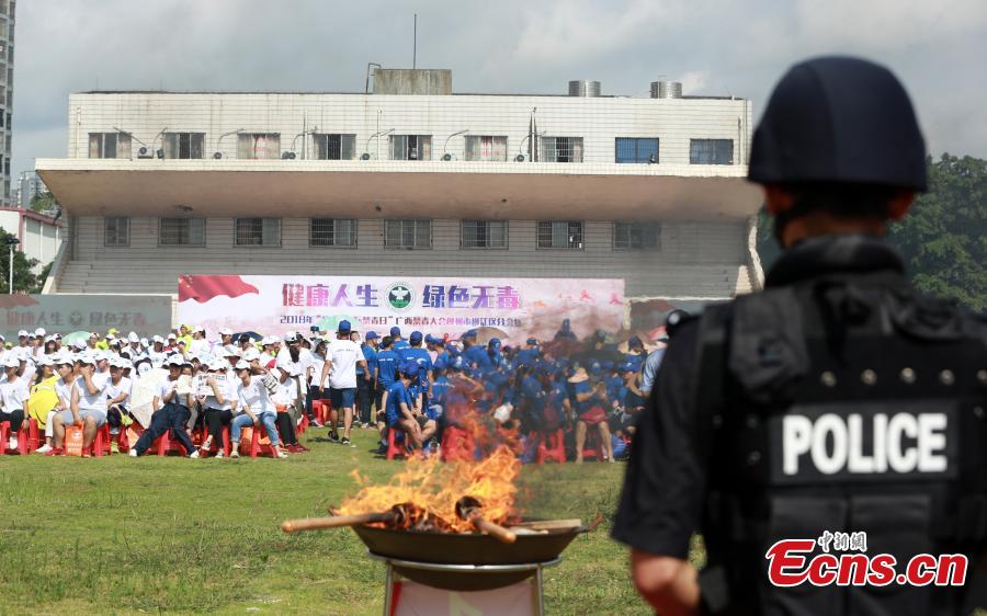 Police burn 40 kilograms of seized drugs in an event to mark the International Day Against Drug Abuse and Illicit Trafficking in Liuzhou City, South China’s Guangxi Zhuang Autonomous Region, June 26, 2018. Over 4,000 people participated the event. (Photo: China News Service/Zhu Liurong)